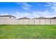 Spacious backyard with a well-maintained lawn and a tall privacy fence, offering ample green space at 9412 Lemon Drop Loop, Ruskin, FL 33573
