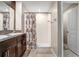 Bright bathroom featuring double sinks, granite countertops, and walk-in shower at 9412 Lemon Drop Loop, Ruskin, FL 33573