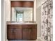 Bathroom featuring double sinks, granite countertops, and a shower with decorative curtain at 9412 Lemon Drop Loop, Ruskin, FL 33573