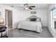 Relaxing bedroom featuring neutral colors, a ceiling fan, and wood-look floors at 9412 Lemon Drop Loop, Ruskin, FL 33573