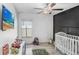 bedroom with a ceiling fan, vibrant decor, and playful elements at 9412 Lemon Drop Loop, Ruskin, FL 33573
