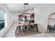 Dining area with a modern light fixture and view into the kitchen and living room at 9412 Lemon Drop Loop, Ruskin, FL 33573