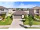 Charming single-Gathering home with a well-manicured front lawn and attached garage at 9412 Lemon Drop Loop, Ruskin, FL 33573