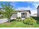 Charming single-story home featuring a well-manicured lawn, attached garage, and cozy front porch with seating at 9412 Lemon Drop Loop, Ruskin, FL 33573
