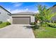 Single Gathering home with a two-car garage and well-maintained lawn at 9412 Lemon Drop Loop, Ruskin, FL 33573