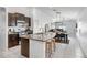 Spacious kitchen featuring dark cabinetry, granite countertops, island seating, and stainless appliances at 9412 Lemon Drop Loop, Ruskin, FL 33573