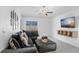 Cozy living room with comfortable seating, ceiling fan, and wall-mounted TV at 9412 Lemon Drop Loop, Ruskin, FL 33573