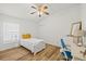 Bedroom featuring wood floors, white walls, a ceiling fan, and a work station at 9826 Laurel Ledge Dr, Riverview, FL 33569