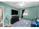 Cozy bedroom with colorful paisley bedding, dresser, ceiling fan, and good natural light at 9860 55Th N St, Pinellas Park, FL 33782