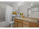 Well-lit bathroom featuring a shower, bathtub combination, vanity with storage, and decorative shelving at 10201 Courtney Palms Blvd # 204, Tampa, FL 33619
