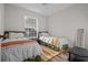 Shared bedroom with a window providing natural light and two comfortable twin beds at 10201 Courtney Palms Blvd # 204, Tampa, FL 33619