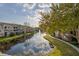 Scenic view of the condominium community with a tranquil lake and fountain at 10201 Courtney Palms Blvd # 204, Tampa, FL 33619