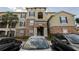 Apartment building featuring a stone facade, multiple windows, and well-maintained landscaping at 10201 Courtney Palms Blvd # 204, Tampa, FL 33619