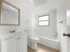 Bright bathroom with large mirror, vanity, toilet, and shower-tub combination at 10323 107Th N Ave, Largo, FL 33773