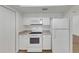 Bright kitchen featuring white appliances, ample cabinetry, and durable countertops at 10323 107Th N Ave, Largo, FL 33773