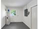 Functional utility room featuring a water heater, window, and ample space at 10323 107Th N Ave, Largo, FL 33773