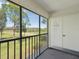 A view from the screened balcony showing a lush green lawn and mature shade trees at 104 Meadow Ln # 104, Oldsmar, FL 34677