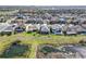 An aerial view highlighting the homes backyard, community, and pond at 11424 Drifting Leaf Dr, Riverview, FL 33579