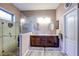 Elegant bathroom with double vanity, framed mirrors, and a spacious tiled shower at 11424 Drifting Leaf Dr, Riverview, FL 33579