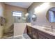 Elegant bathroom featuring tiled shower with a glass enclosure and a granite countertop at 11424 Drifting Leaf Dr, Riverview, FL 33579
