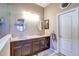 Bathroom featuring double sinks and vanity with decorative framed mirror and a white paneled door at 11424 Drifting Leaf Dr, Riverview, FL 33579