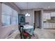 Dining area featuring a round table with four chairs set on tiled floor, and a rustic cabinet at 11424 Drifting Leaf Dr, Riverview, FL 33579