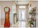 The welcoming home foyer boasts a grand grandfather clock, lovely decor, and lots of natural light at 11424 Drifting Leaf Dr, Riverview, FL 33579