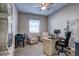 Bright office features a desk, office chair, sitting chairs, and a grandfather clock at 11424 Drifting Leaf Dr, Riverview, FL 33579