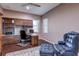 Office with built-in desk, cabinets, and a comfortable chair with ottoman at 11424 Drifting Leaf Dr, Riverview, FL 33579