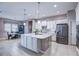 Spacious kitchen with large island, stainless steel refrigerator, granite countertops and ample cabinet space at 11424 Drifting Leaf Dr, Riverview, FL 33579