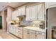 Bright kitchen featuring white cabinets, granite countertops, stainless steel appliances, and a mosaic tile backsplash at 11424 Drifting Leaf Dr, Riverview, FL 33579