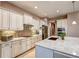 Bright kitchen features white cabinets, granite countertops, stainless appliances, and mosaic tile backsplash at 11424 Drifting Leaf Dr, Riverview, FL 33579