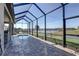 Inviting screened lanai with hot tub and serene views of the surrounding landscape at 11424 Drifting Leaf Dr, Riverview, FL 33579
