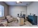 Inviting office space features a ceiling fan, window, a wooden desk, and a black accent cabinet at 11424 Drifting Leaf Dr, Riverview, FL 33579