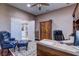 Spacious office with a desk, chair, a wooden armoire, and a comfortable chair with a matching ottoman at 11424 Drifting Leaf Dr, Riverview, FL 33579