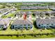 Aerial view of townhome showcasing backyard patios and well-maintained landscaping at 11648 Crowned Sparrow Ln, Tampa, FL 33626