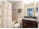 Cozy bathroom features a bathtub with a shower and a floral shower curtain for a refreshing experience at 11648 Crowned Sparrow Ln, Tampa, FL 33626