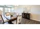 Inviting dining area with dark wood table, decorative mirror, and seamless flow into the living space at 11648 Crowned Sparrow Ln, Tampa, FL 33626
