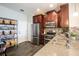 Bright kitchen featuring stainless steel appliances, granite counters, ample storage, and wood-look flooring at 11648 Crowned Sparrow Ln, Tampa, FL 33626