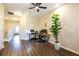 Spacious office/flex space with modern wood flooring, a ceiling fan, and a large potted plant for added flair at 11648 Crowned Sparrow Ln, Tampa, FL 33626