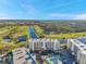 Aerial view of the building near a golf course, lake, and mature trees at 1200 Country Club Dr # 2206, Largo, FL 33771