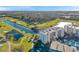 Aerial view of the building near a golf course, lake, and mature trees at 1200 Country Club Dr # 2206, Largo, FL 33771