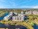 Beautiful aerial view of condo buildings, landscaping and golf course, nestled beside a serene lake at 1200 Country Club Dr # 2206, Largo, FL 33771