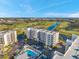 An aerial view of condo buildings and a nearby pool, pond, and golf course at 1200 Country Club Dr # 2206, Largo, FL 33771