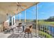 Relaxing screened balcony with outdoor seating and beautiful views of the golf course and pond at 1200 Country Club Dr # 2206, Largo, FL 33771