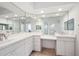 Bright bathroom featuring a double vanity with ample counter space and a large mirror reflecting the natural light at 1200 Country Club Dr # 2206, Largo, FL 33771