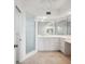 Bright bathroom featuring a glass shower stall, single sink, and white cabinets providing ample storage at 1200 Country Club Dr # 2206, Largo, FL 33771