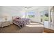 Bright bedroom with natural light, a ceiling fan, and a door to the balcony at 1200 Country Club Dr # 2206, Largo, FL 33771