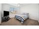 Bright bedroom featuring a queen bed, ceiling fan, and a window with blinds at 1200 Country Club Dr # 2206, Largo, FL 33771