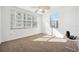 Bedroom with carpet flooring, two windows offering exterior views, and a ceiling fan at 1200 Country Club Dr # 2206, Largo, FL 33771